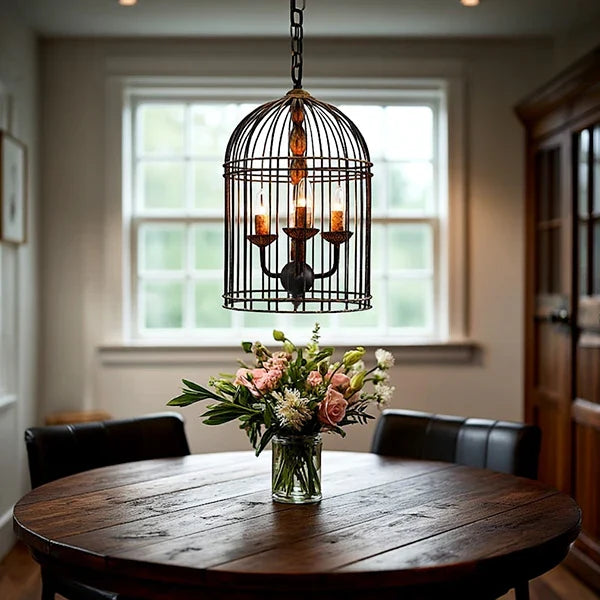 Rustic metal bird cage pendant lamp with distressed finish and candelabra bulb holders, hanging by chain in Rustic Kitchen Dining