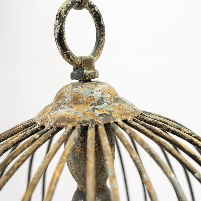 Rustic metal bird cage pendant lamp with distressed finish and candelabra bulb holders, hanging by chain top view