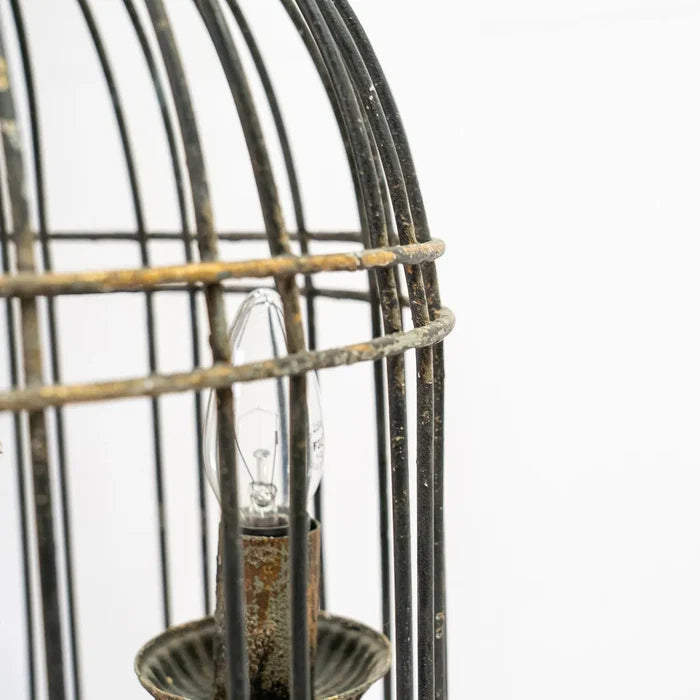 Rustic metal bird cage pendant lamp with distressed finish and candelabra bulb holders, hanging by chain side view