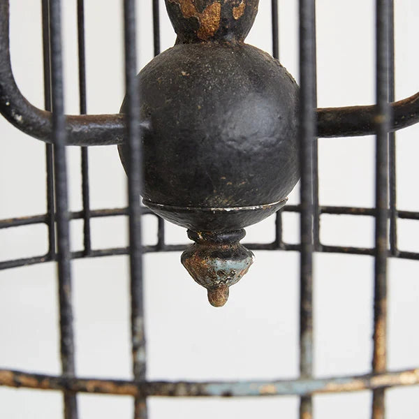 Rustic metal bird cage pendant lamp with distressed finish and candelabra bulb holders, hanging by chain lower view