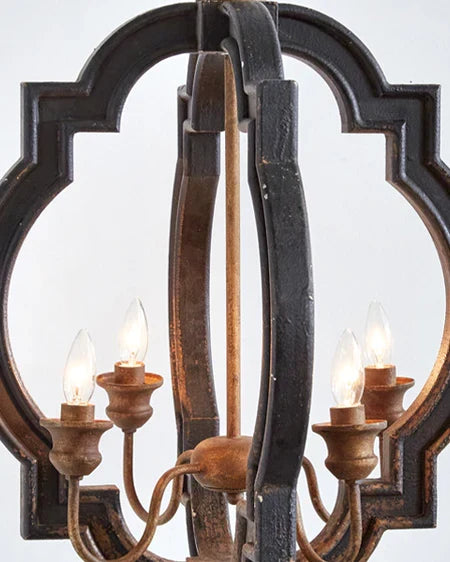 Rustic farmhouse bird cage pendant lamp in distressed metal finish with three candelabra bulb holders, hanging by decorative chain close up