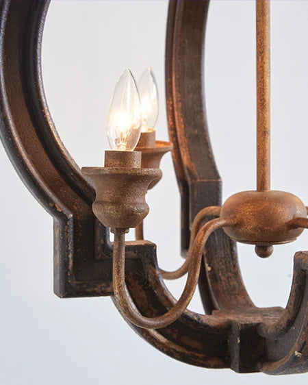 Rustic farmhouse bird cage pendant lamp in distressed metal finish with three candelabra bulb holders, hanging by decorative chain close up side