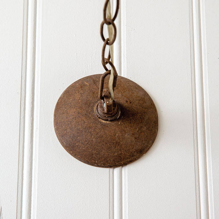Rustic farmhouse bird cage pendant lamp in distressed metal finish with three candelabra bulb holders, hanging by decorative chain installed
