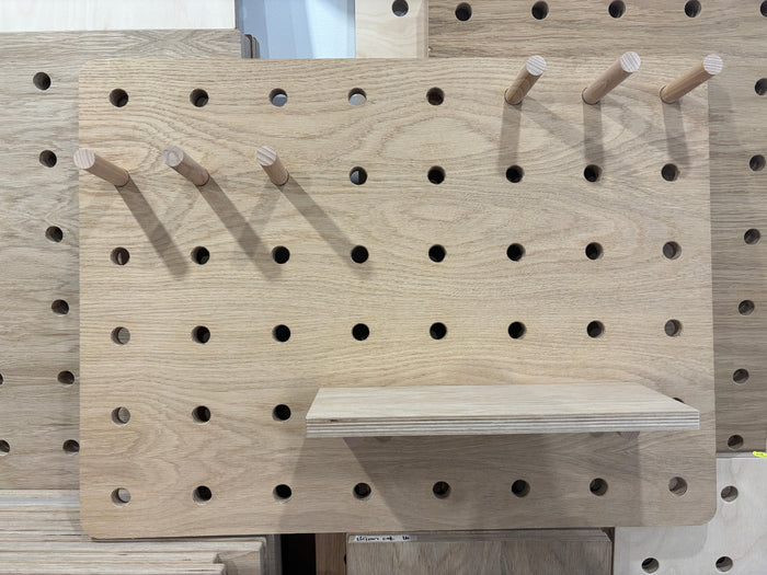 Oak pegboard with shelf and solid wood pegs by kreisdesign