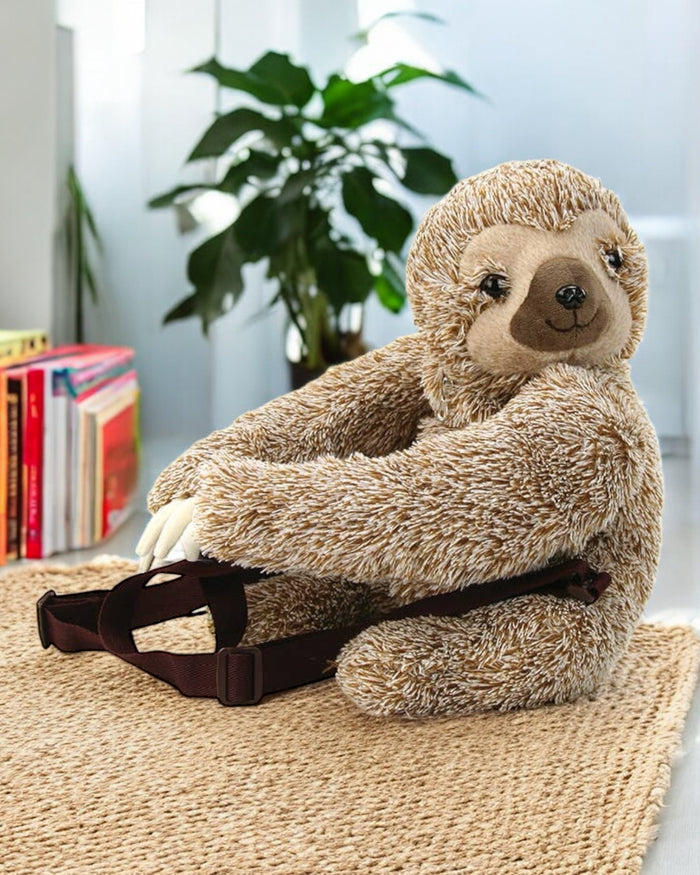 Sloth furry backpack front view showing adorable sleepy-eyed sloth face with ultra-soft brown plush fur exterior, white background