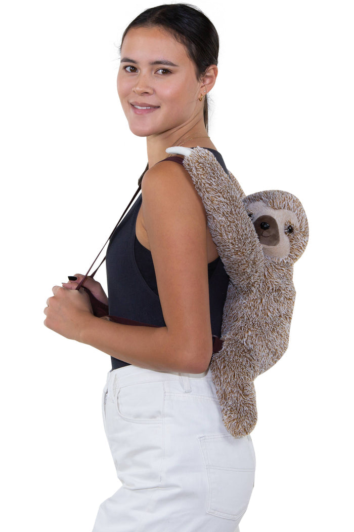 Sloth furry backpack worn on back showing adjustable padded straps and full 24-inch height on child model, white background