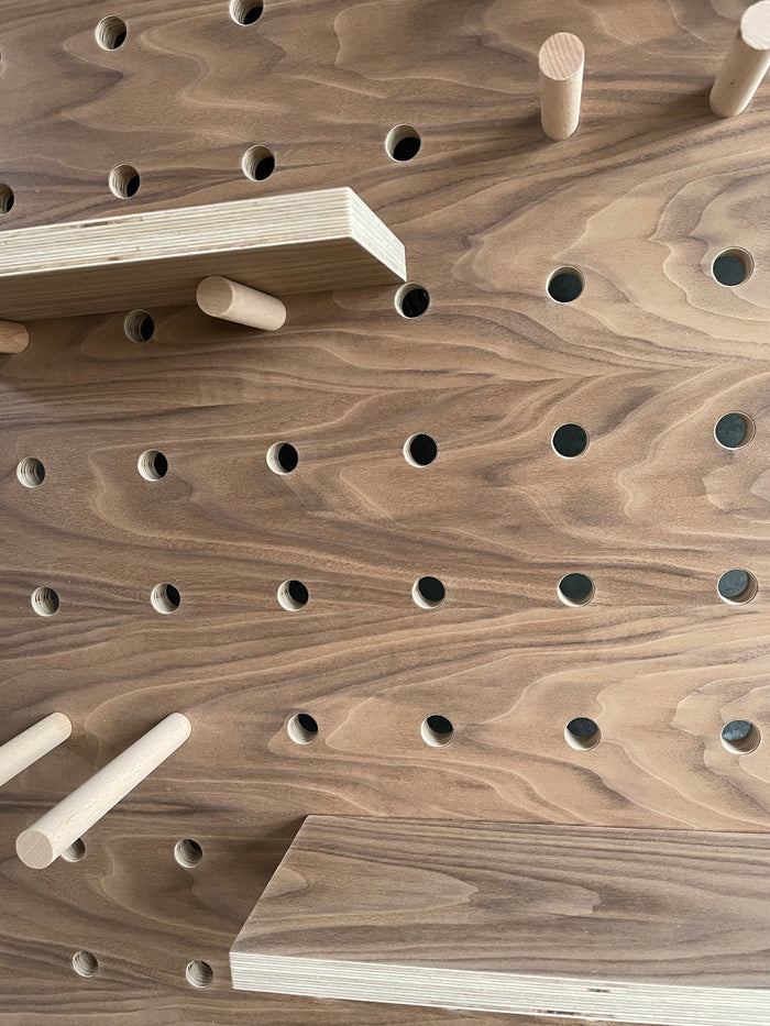 detail of walnut pegboard by kreisdesign