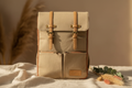 Bon Secour canvas diaper backpack on warm natural linen surface with pampas grass