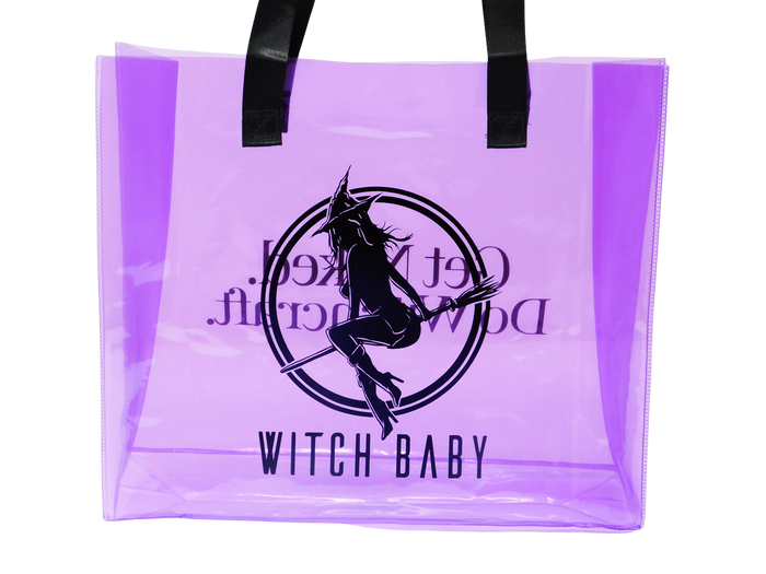 witch baby logo on one side of purple translucent tote bag with black handles