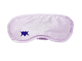 Photo of light lilac colored sleep mask with a symbol on the bottom left corner that is a heart with two crescent moons.